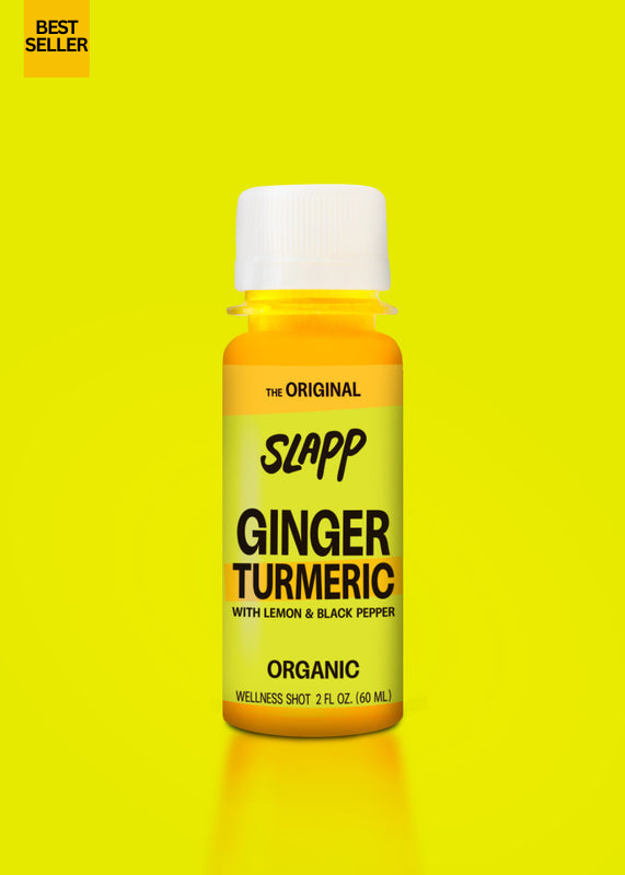 Slapp brand ginger turmeric wellness shot bottle on yellow background.